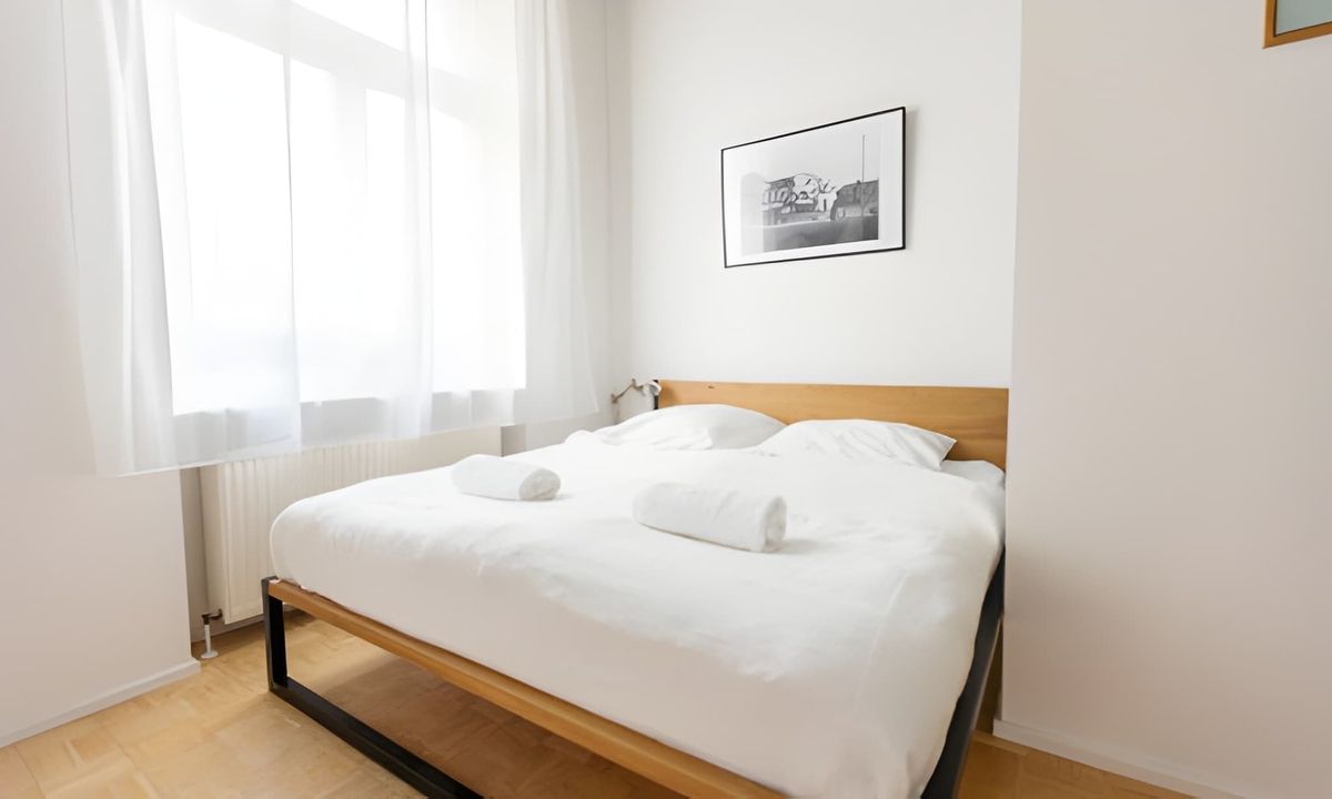 Spacious bedroom with large windows and plenty of natural light.